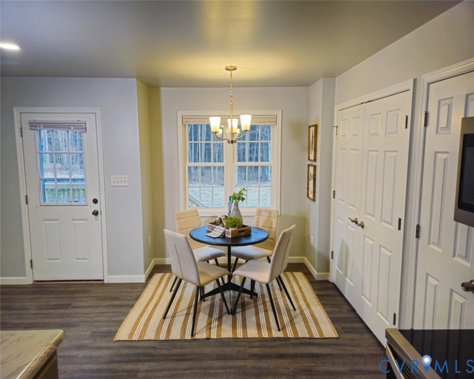 450 Wyatts Mill Road Jarratt, VA 23867 - Photo 10 of 16 a dining room with furniture and wooden floor
