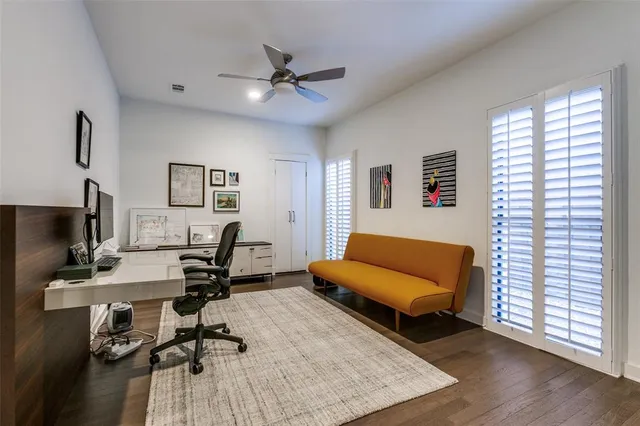 a view of a livingroom with workspace and a window
