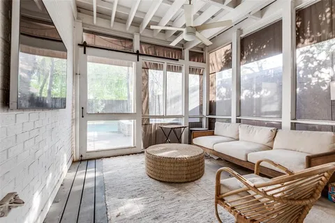 a living room with furniture and a floor to ceiling window