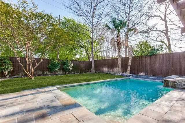 a view of a backyard with wooden fence