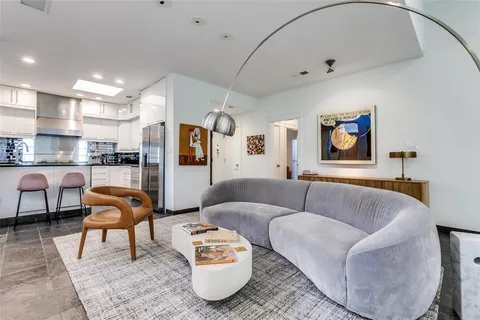 a living room with furniture and kitchen view