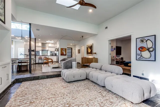 a living room with furniture and kitchen view