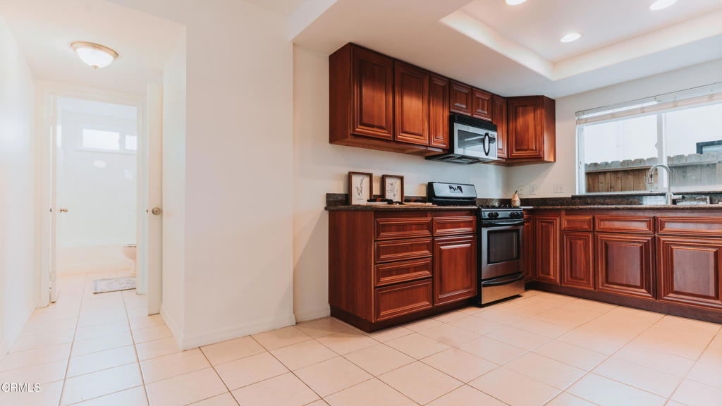 1022 Dunes Street, Unit 1022 Oxnard, CA 93035 - Photo 12 of 68 a kitchen with stainless steel appliances granite countertop a stove and a sink