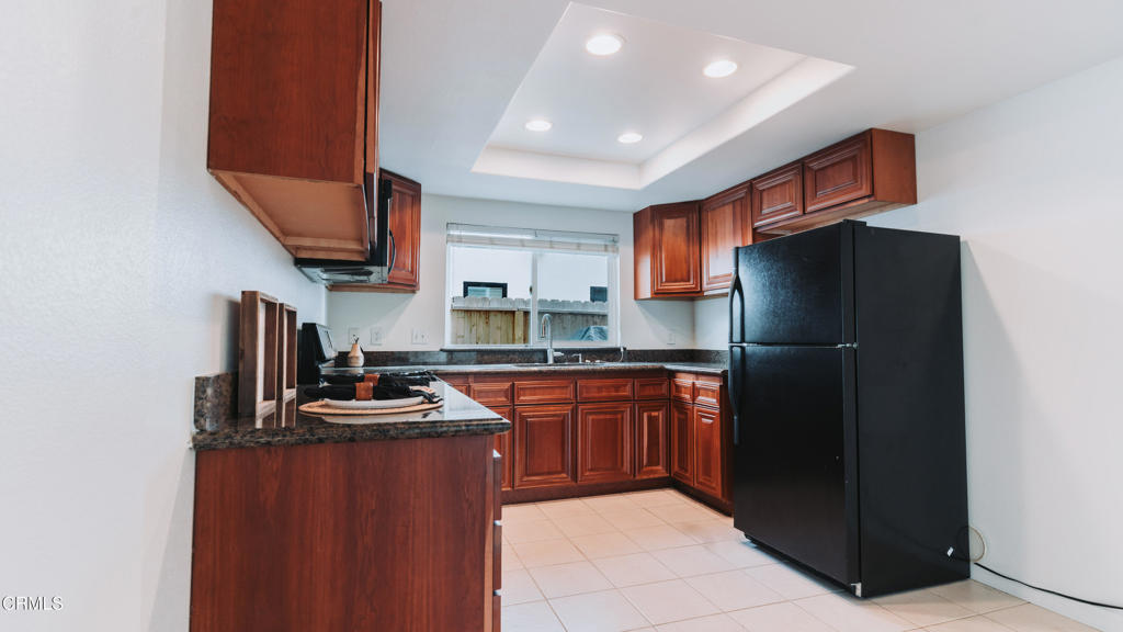 1022 Dunes Street, Unit 1022 Oxnard, CA 93035 - Photo 13 of 68 a kitchen with stainless steel appliances granite countertop a refrigerator and a stove