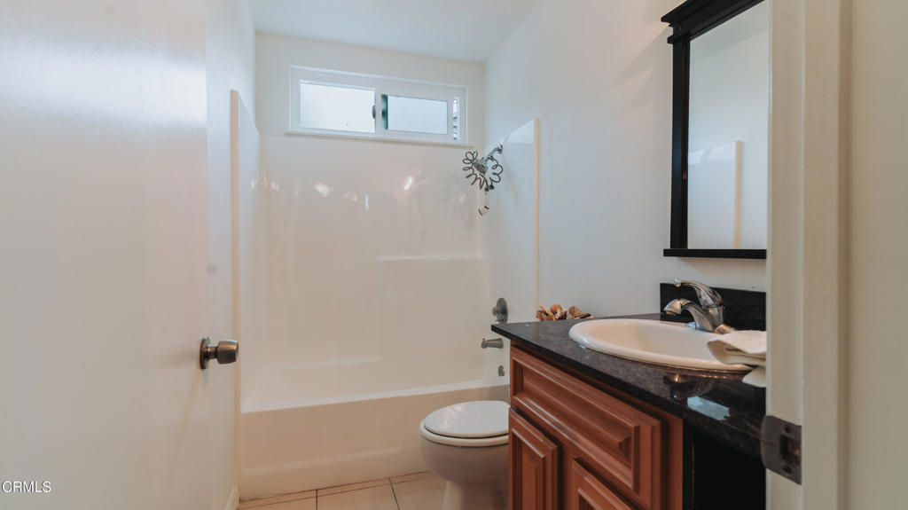 1022 Dunes Street, Unit 1022 Oxnard, CA 93035 - Photo 15 of 68 a bathroom with a sink a toilet and shower
