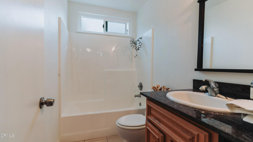 1022 Dunes Street, Unit 1022 Oxnard, CA 93035 - Photo 16 of 68 a bathroom with a sink toilet and shower
