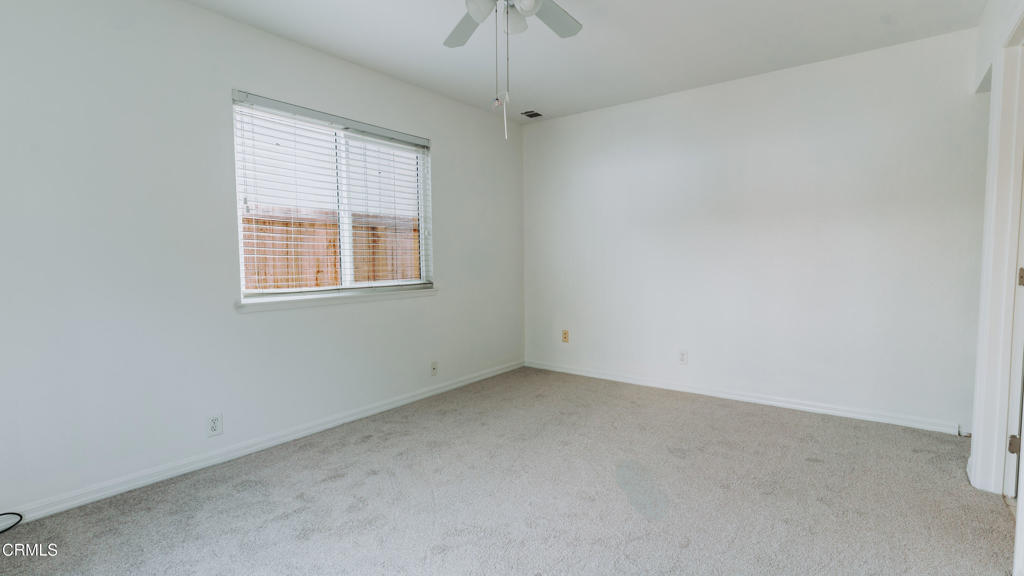 1022 Dunes Street, Unit 1022 Oxnard, CA 93035 - Photo 21 of 68 an empty room with a window and a ceiling fan