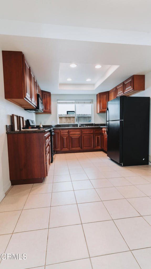 1022 Dunes Street, Unit 1022 Oxnard, CA 93035 - Photo 24 of 68 a large kitchen with stainless steel appliances a counter a sink a stove a microwave and cabinets
