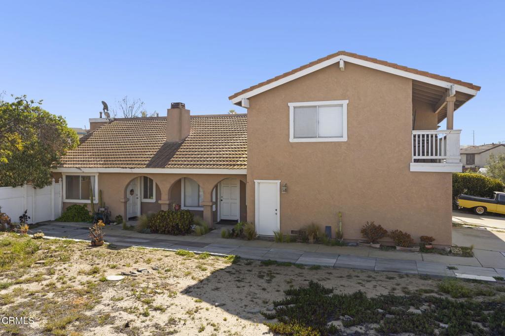 1022 Dunes Street, Unit 1022 Oxnard, CA 93035 - Photo 45 of 68 a front view of a house with a yard