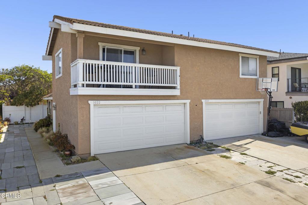 1022 Dunes Street, Unit 1022 Oxnard, CA 93035 - Photo 46 of 68 a front view of a house with a garage