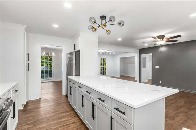 a large white kitchen with a large window