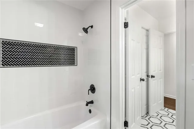 a bathroom with a bathtub and a shower