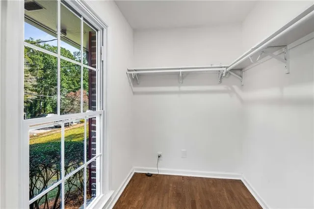 a view of walk in closet with empty racks
