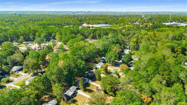 a view of a city with lush green forest