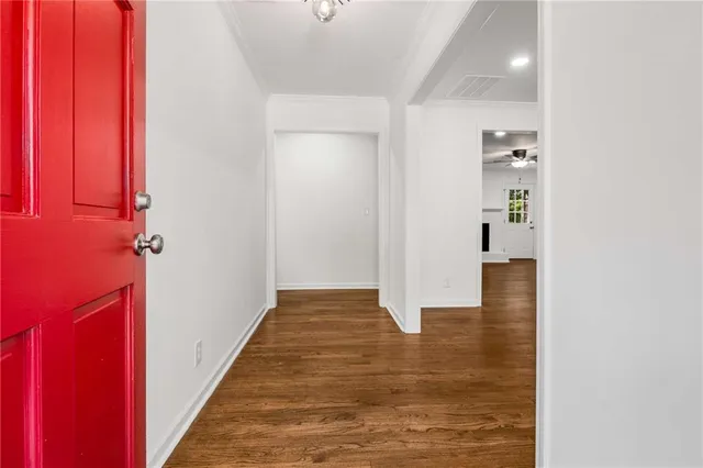 a view of a hallway with wooden floor