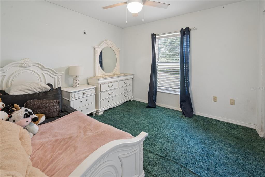 1750 Southwest 15th Street Bell, FL 32619 - Photo 16 of 34 a bed room with a bed and a chandelier