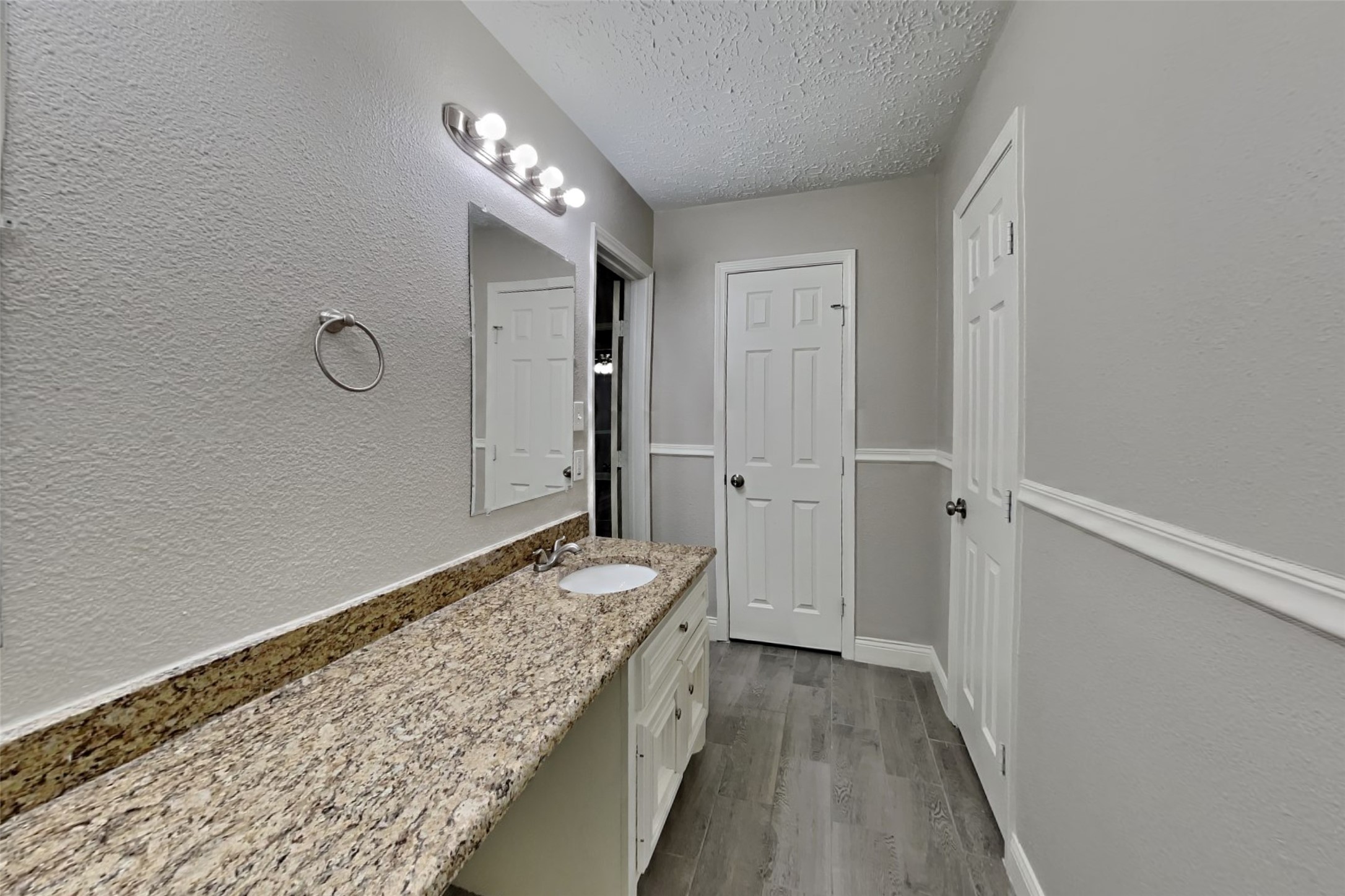 12706 Pantano Drive Houston, TX 77065 - Photo 12 of 18 a spacious bathroom with a granite countertop sink and a mirror