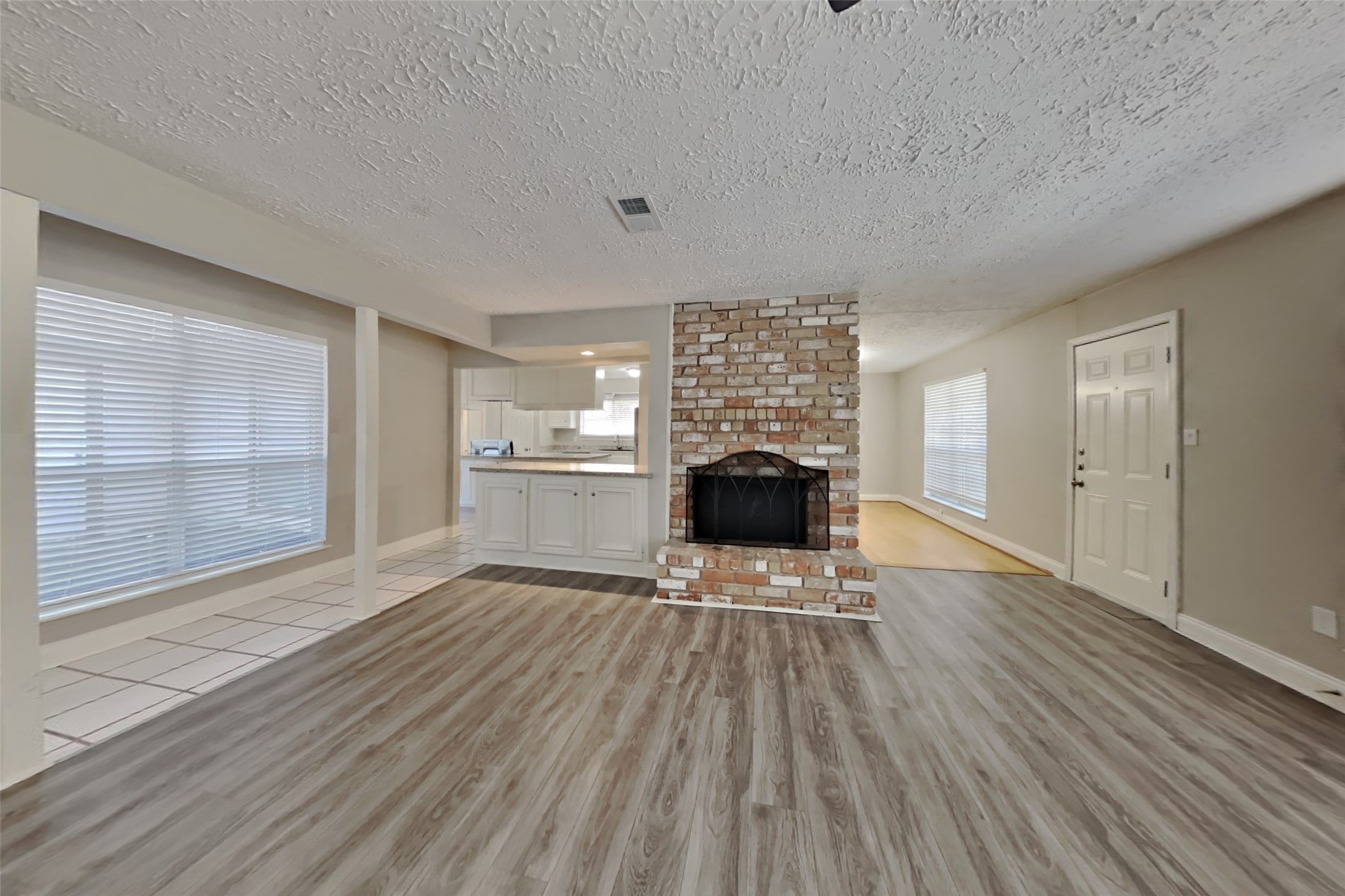 12706 Pantano Drive Houston, TX 77065 - Photo 3 of 18 a view of empty room with wooden floor and fireplace