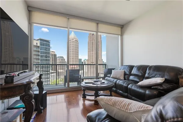 a living room with furniture and a floor to ceiling window