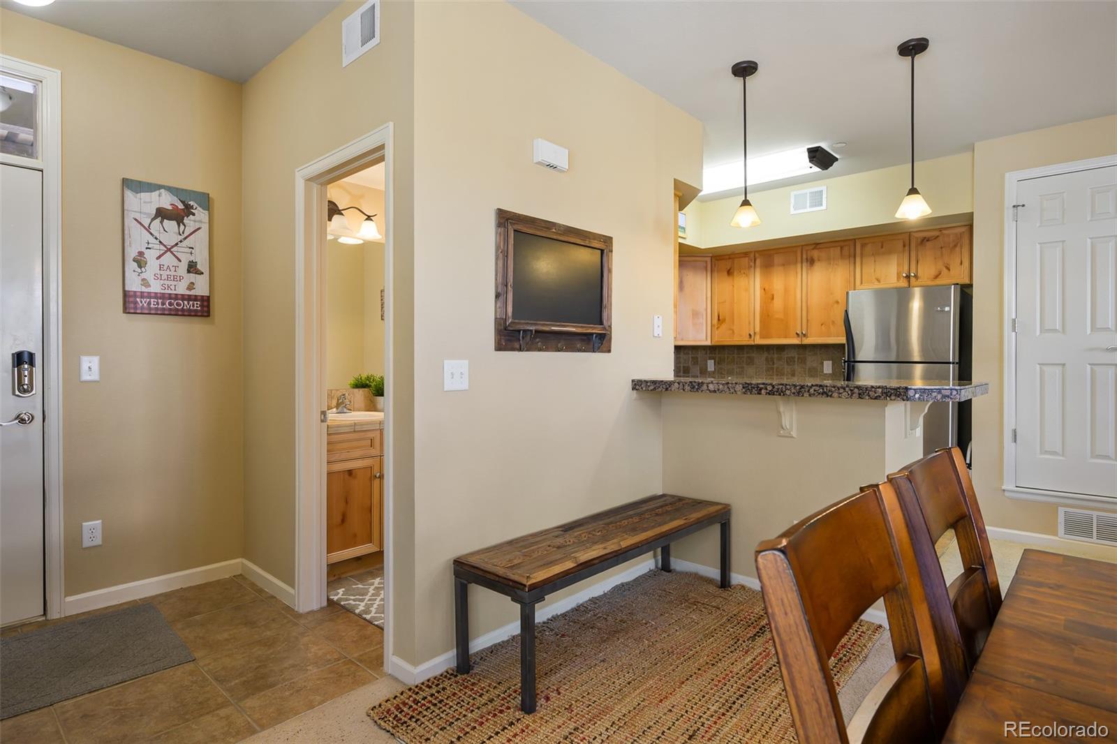 180 County Road, Unit 1 Fraser, CO 80442 - Photo 16 of 37 a room with stainless steel appliances kitchen island granite countertop furniture and a wooden floor