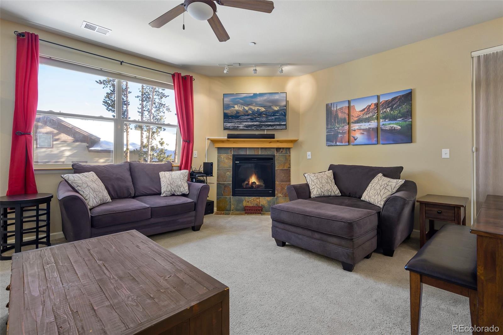 180 County Road, Unit 1 Fraser, CO 80442 - Photo 17 of 37 a living room with furniture fireplace and a large window