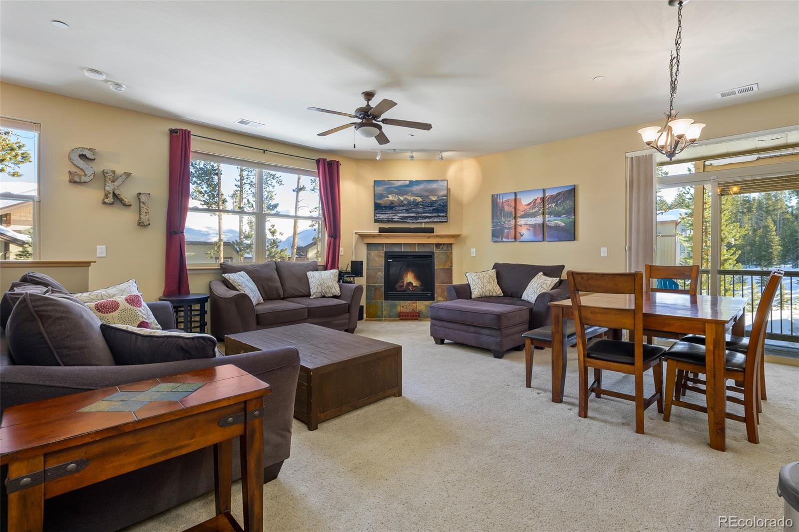 180 County Road, Unit 1 Fraser, CO 80442 - Photo 19 of 37 a living room with furniture a fireplace and a flat screen tv