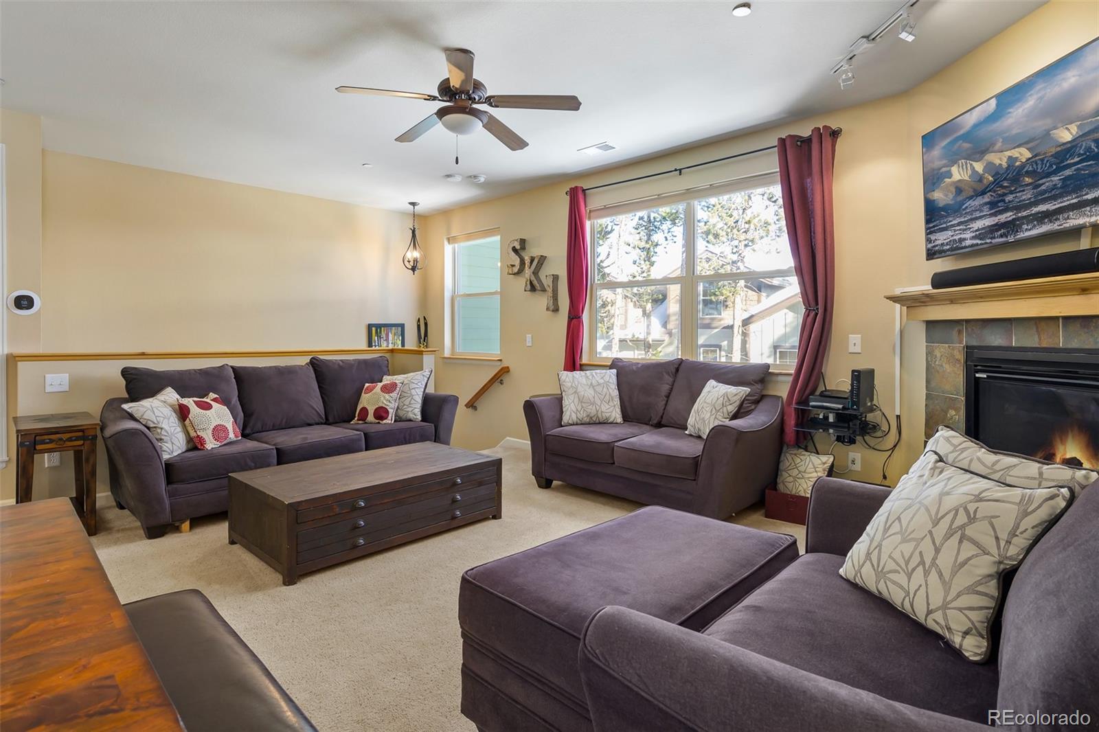 180 County Road, Unit 1 Fraser, CO 80442 - Photo 21 of 37 a living room with furniture ceiling fan and a window