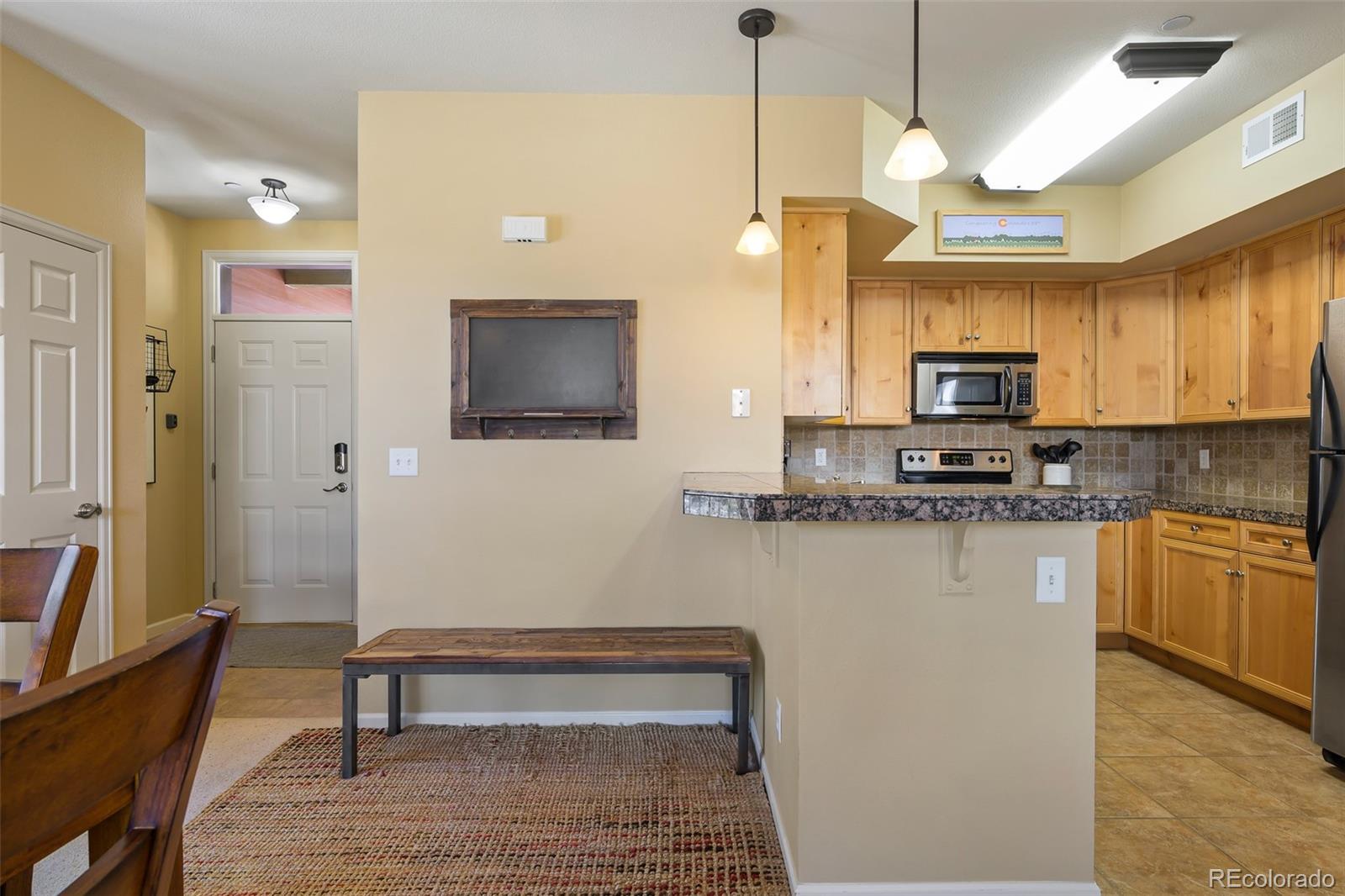 180 County Road, Unit 1 Fraser, CO 80442 - Photo 22 of 37 a kitchen with stainless steel appliances granite countertop a stove a sink and a refrigerator