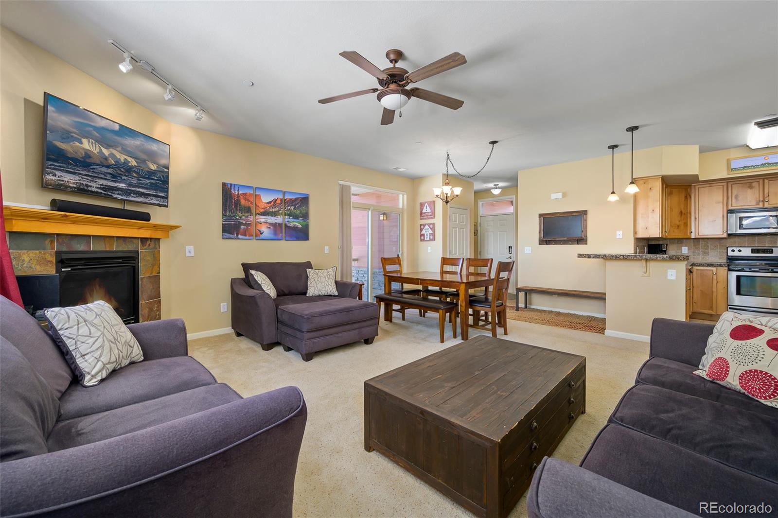 180 County Road, Unit 1 Fraser, CO 80442 - Photo 28 of 37 a living room with furniture kitchen view and a fireplace