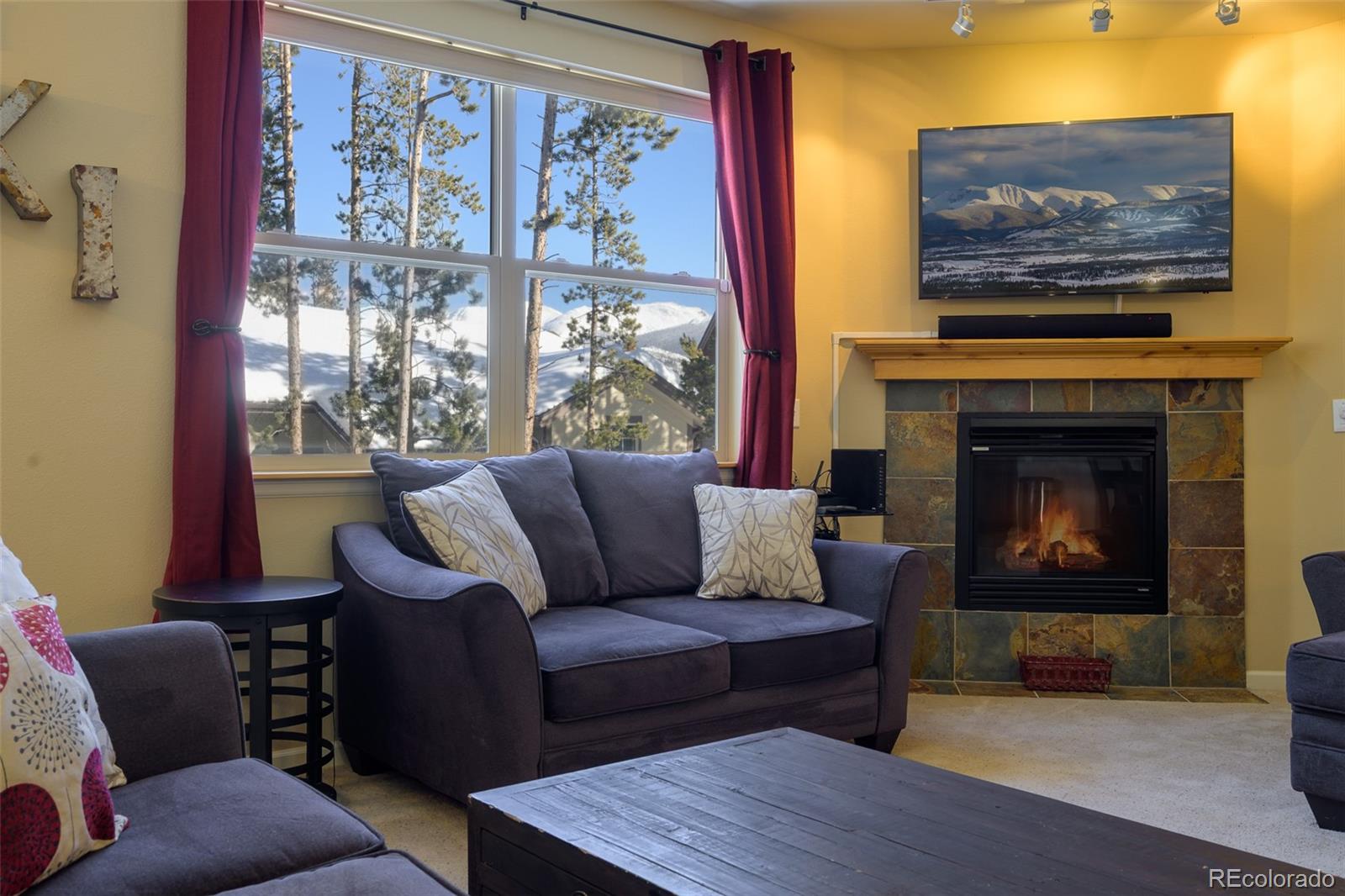 180 County Road, Unit 1 Fraser, CO 80442 - Photo 29 of 37 a living room with furniture and a fireplace