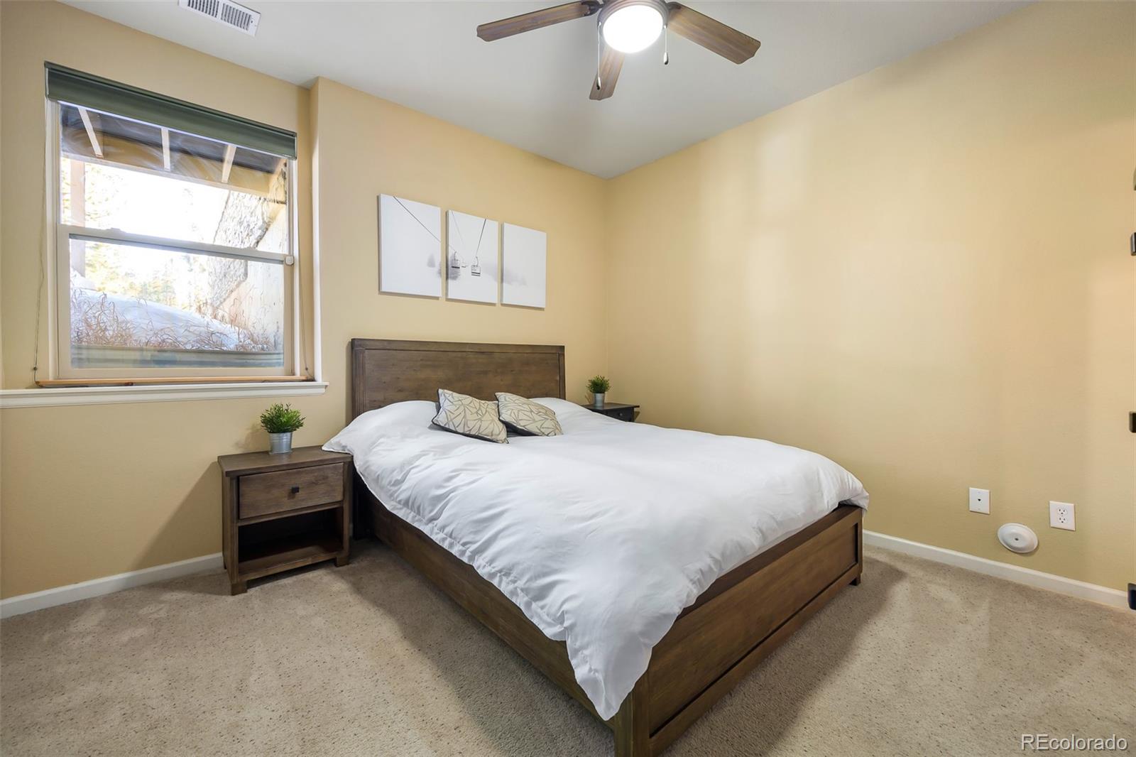 180 County Road, Unit 1 Fraser, CO 80442 - Photo 31 of 37 a bedroom with a bed and a window