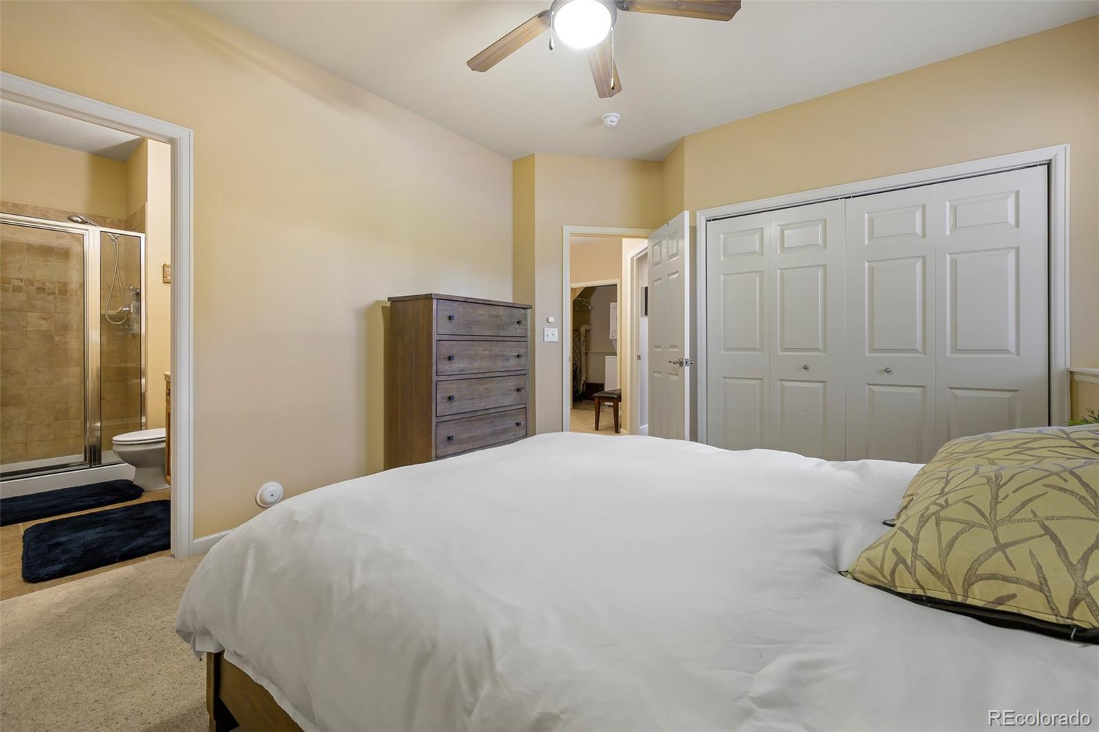 180 County Road, Unit 1 Fraser, CO 80442 - Photo 33 of 37 a bedroom with a bed and a chandelier