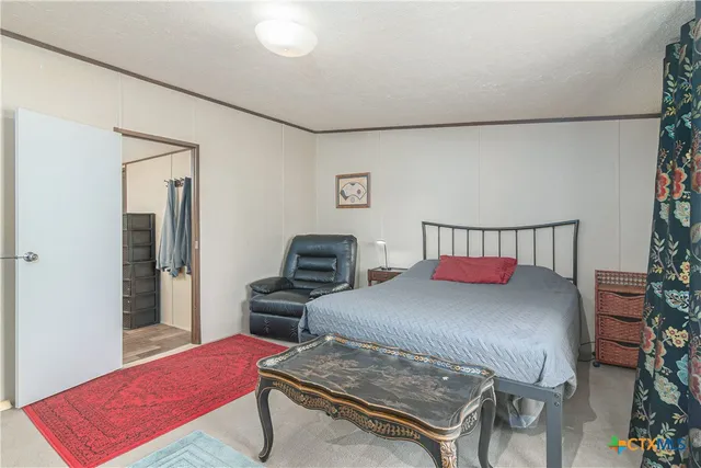 a bedroom with a bed and a dresser in it