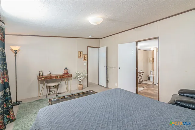 a bedroom with a bed and a table in it