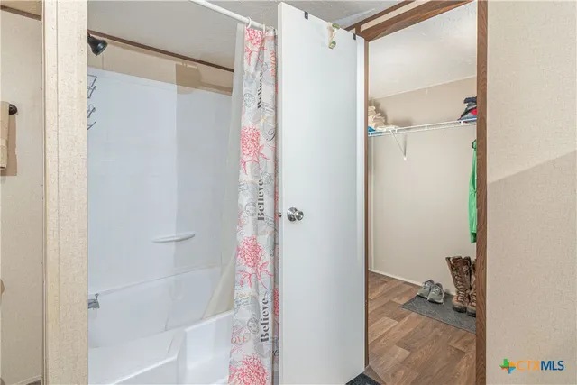 a bathroom with a bathtub and a shower