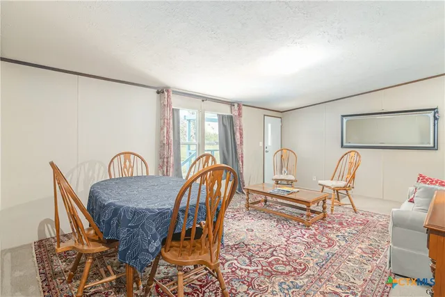 a dining room with furniture and wooden floor