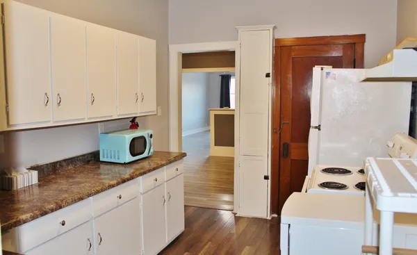 a kitchen with stainless steel appliances granite countertop a sink and a stove with wooden floor
