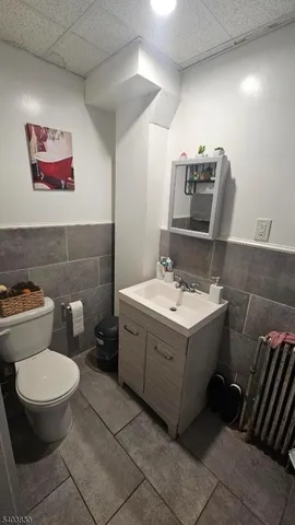 a bathroom with a sink toilet and mirror