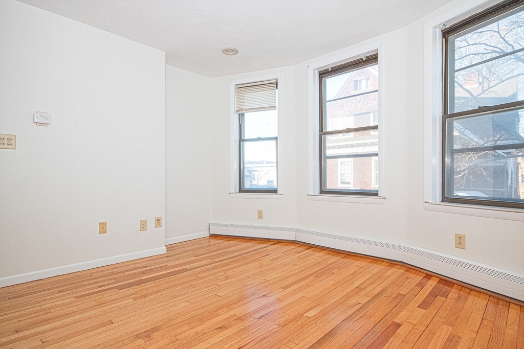 29 William Street, Unit 22 Worcester, MA 01609 - Photo 11 of 14 an empty room with wooden floor and windows