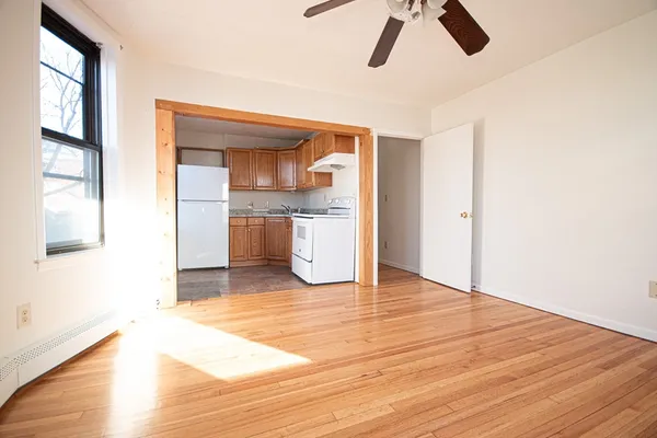 a view of a kitchen cabinets a sink and wooden floor