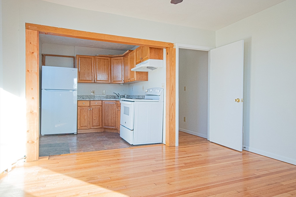 29 William Street, Unit 22 Worcester, MA 01609 - Photo 4 of 14 a kitchen with a sink cabinets and wooden floor