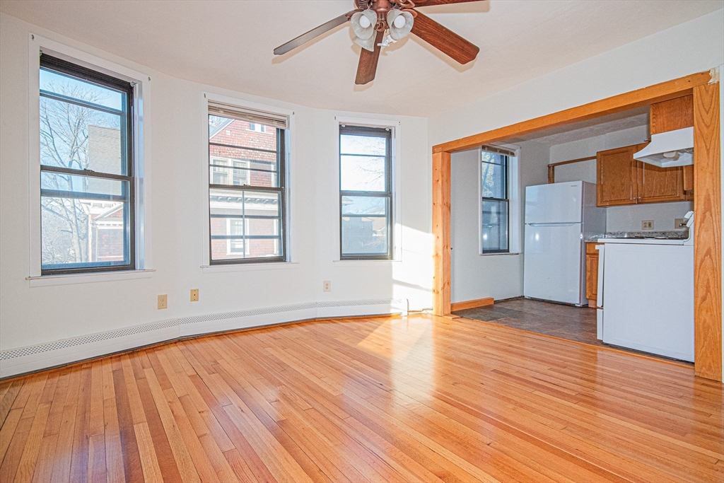 29 William Street, Unit 22 Worcester, MA 01609 - Photo 6 of 14 a view of empty room with wooden floor and fan