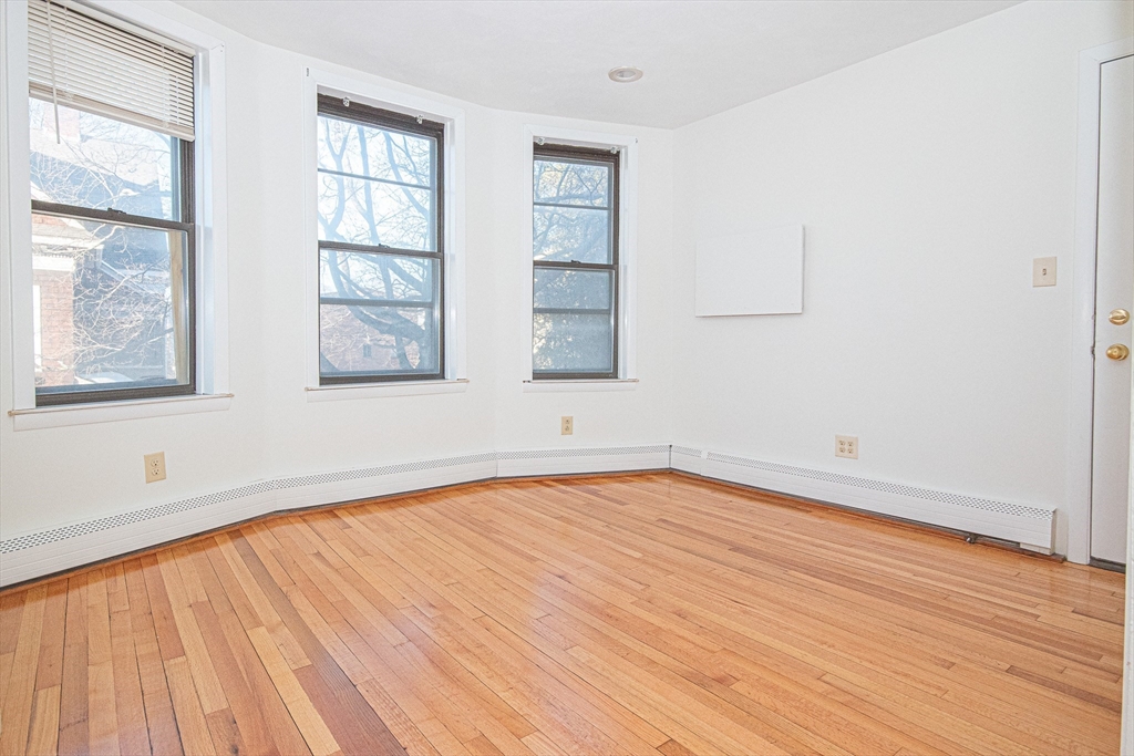 29 William Street, Unit 22 Worcester, MA 01609 - Photo 10 of 14 an empty room with wooden floor and windows