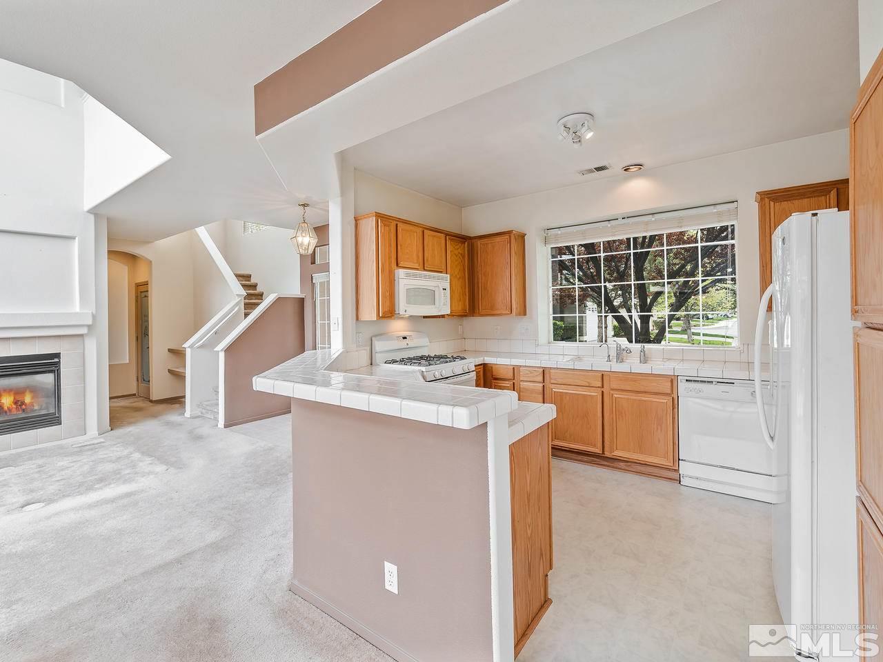 1287 Tule Drive Reno, NV 89521 - Photo 12 of 32 a kitchen with counter top space and windows
