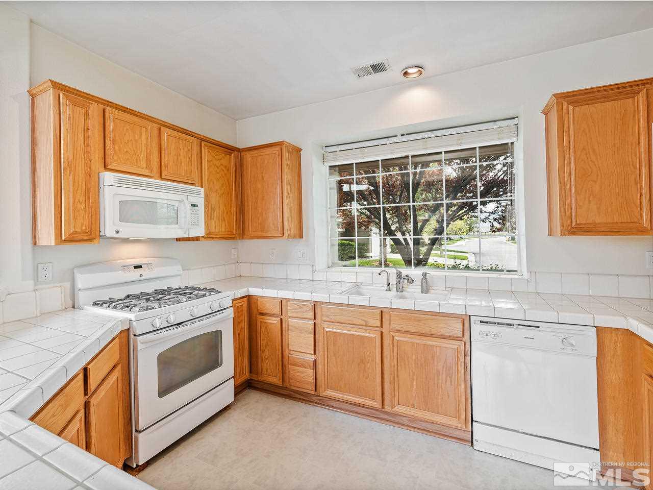 1287 Tule Drive Reno, NV 89521 - Photo 13 of 32 a kitchen with a sink stove and cabinets