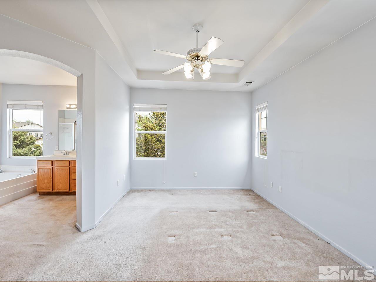 1287 Tule Drive Reno, NV 89521 - Photo 19 of 32 an empty room with windows and fan