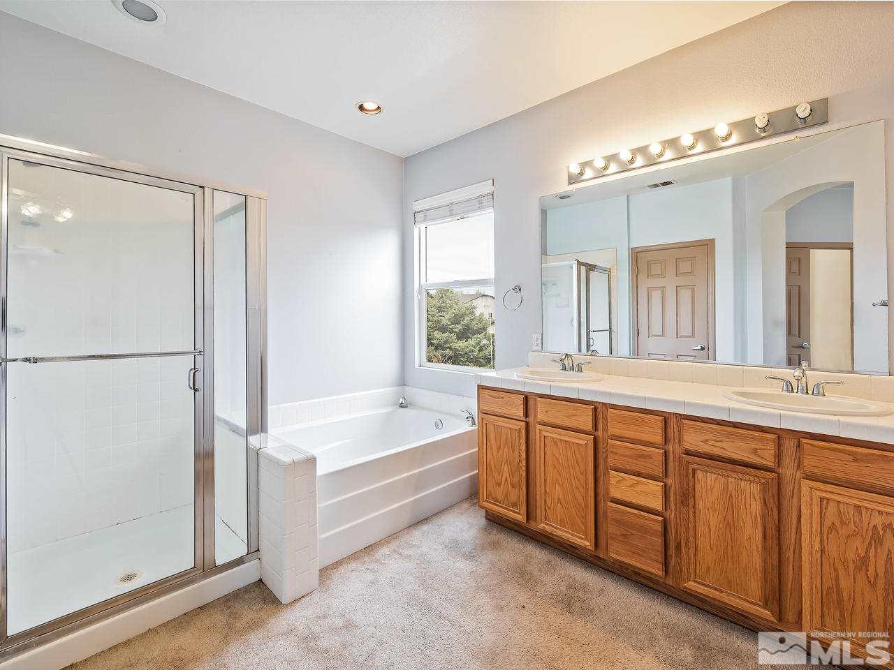 1287 Tule Drive Reno, NV 89521 - Photo 20 of 32 a spacious bathroom with a tub sink and mirror