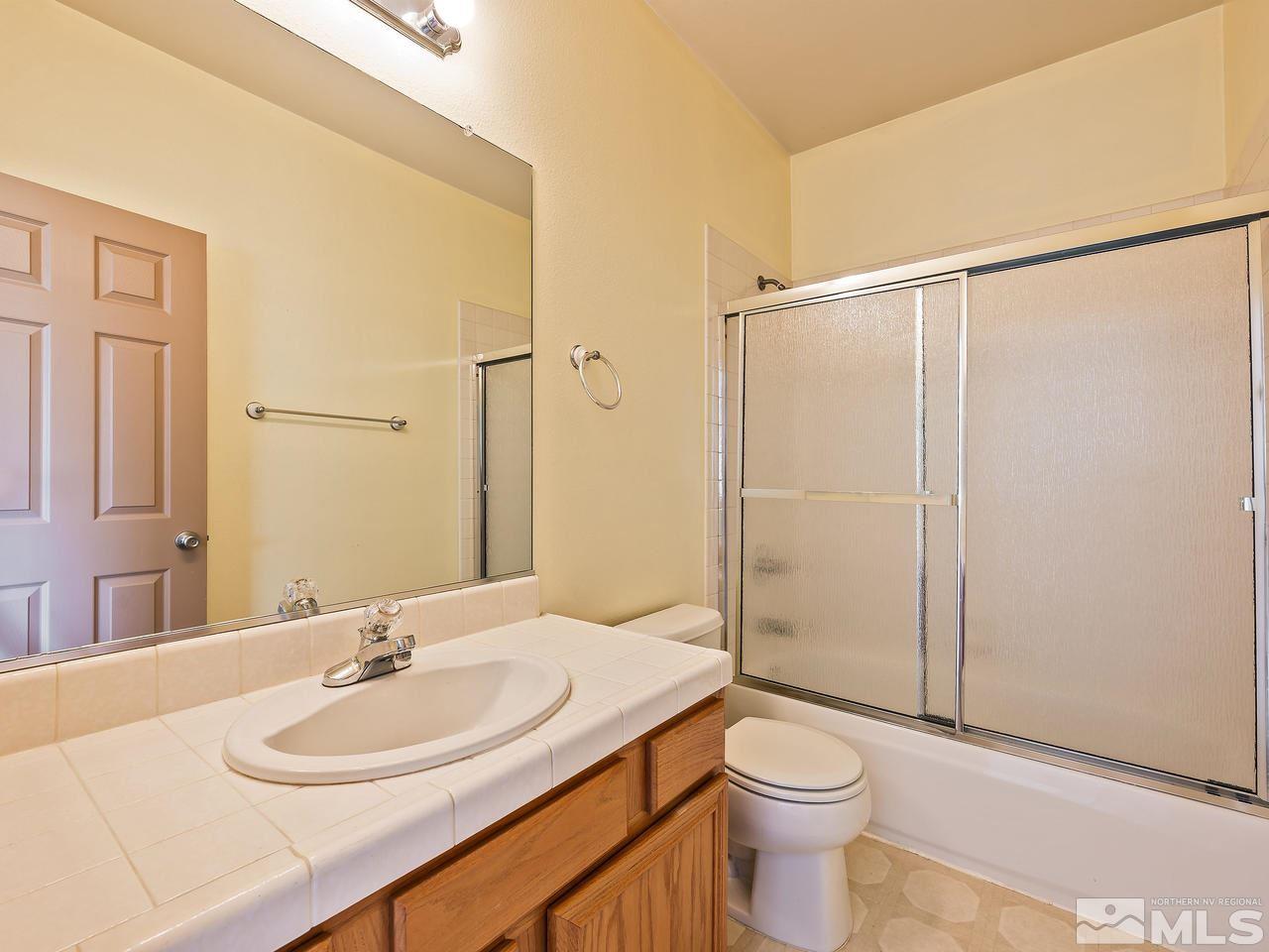 1287 Tule Drive Reno, NV 89521 - Photo 24 of 32 a bathroom with a sink a toilet and shower