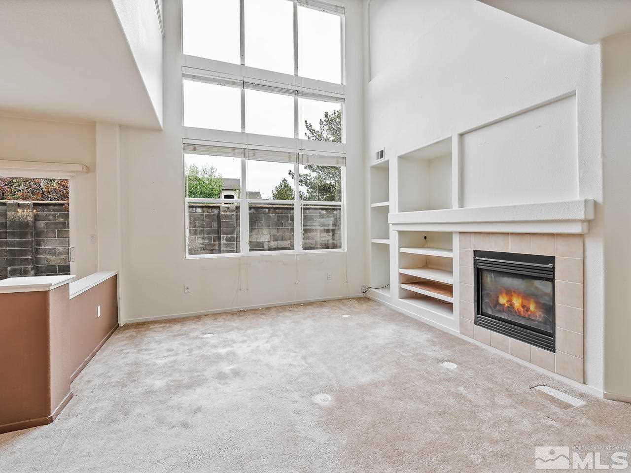 1287 Tule Drive Reno, NV 89521 - Photo 4 of 32 a view of an empty room with a fireplace