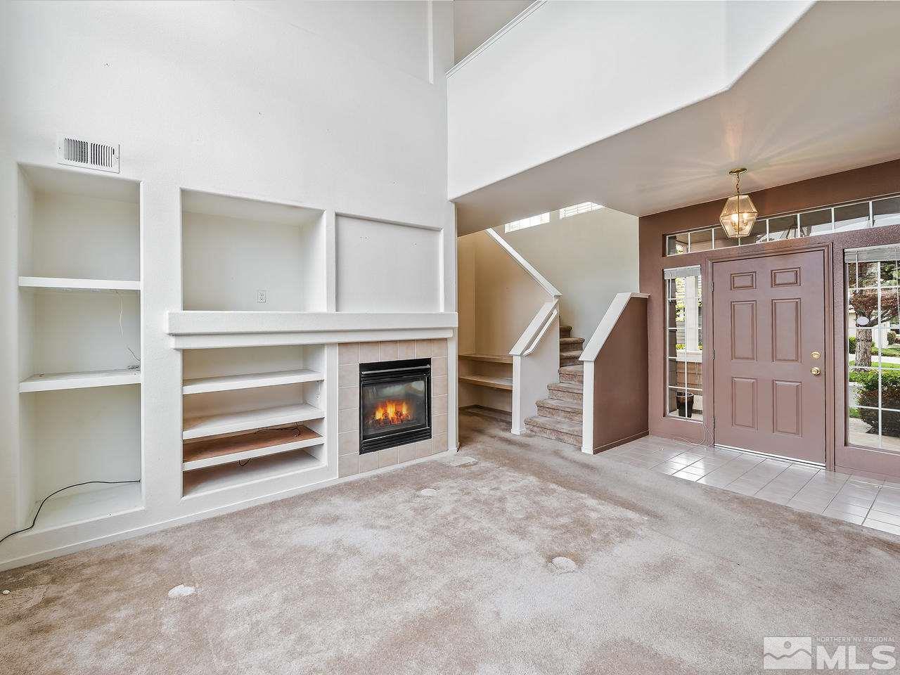 1287 Tule Drive Reno, NV 89521 - Photo 8 of 32 a view of an empty room with fireplace and a window